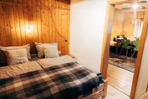 a bedroom with a bed with a wooden wall at Zauberhuette Wildschoenau in Oberau