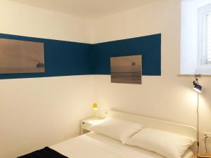 a bedroom with a blue accent wall and a bed at Apartment P 35 in Dubrovnik