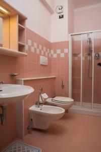 a bathroom with a toilet and a sink and a shower at Hotel Marcelli in Numana