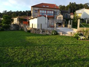 a house with a green field in front of it at Casa Bravo in Gondomar