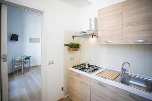 a kitchen with a sink and a stove top oven at Isola Blu in Siracusa