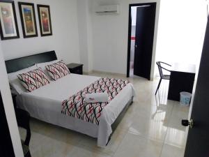 Ένα ή περισσότερα κρεβάτια σε δωμάτιο στο Hotel Cosmos Sincelejo
