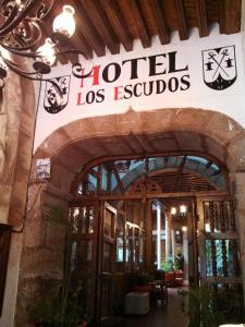 a hotel los equosias sign on the front of a building at Hotel Los Escudos in P&aacute;tzcuaro