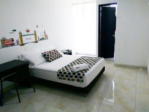 Ένα ή περισσότερα κρεβάτια σε δωμάτιο στο Hotel Cosmos Sincelejo
