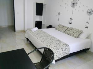 Ένα ή περισσότερα κρεβάτια σε δωμάτιο στο Hotel Cosmos Sincelejo