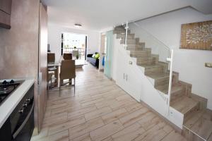 a kitchen and dining room with a staircase in a house at Parque Santiago Luxury 306 in Arona