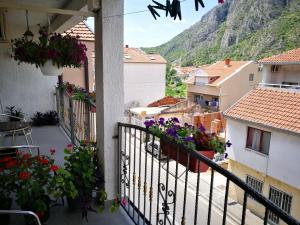 a view from a balcony of a town with flowers at Balkaneros Hostel in Mostar