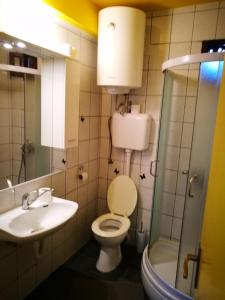a bathroom with a toilet and a sink and a shower at Balkaneros Hostel in Mostar