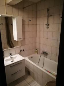 a bathroom with a tub and a sink and a bath tub at Balkaneros Hostel in Mostar