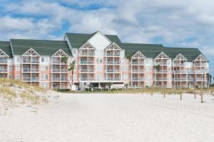 a large hotel on the beach with a beach at Grand Beach Resort Unit 313 in Gulf Shores