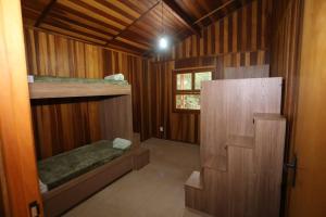 a small room with two bunk beds and a window at Sitio Bom Tempo in Miguel Pereira +18 photos