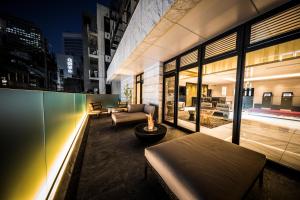 a living area of a building with a fire pit at The Rise Osaka Kitashinchi in Osaka