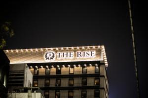 a building with the rise lit up at night at The Rise Osaka Kitashinchi in Osaka