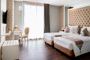 Postel nebo postele na pokoji v ubytování Savero Hotel Depok