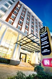 a large building with a sign in front of it at Savero Hotel Depok in Depok