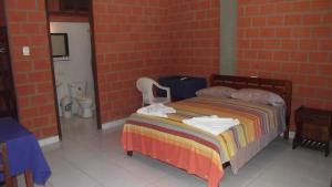 Postel nebo postele na pokoji v ubytování Hotel Ambaibo