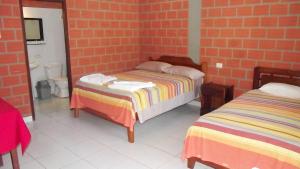 Postel nebo postele na pokoji v ubytování Hotel Ambaibo