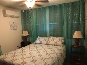 A bed or beds in a room at Luquillo Beach Vacation