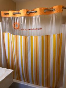 a shower curtain that says wake up on the right side at Encore Motel in Los Angeles