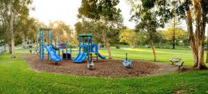a playground in a park with two slides at BIG4 Sawtell Beach Holiday Park in Sawtell