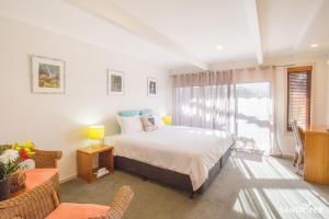 a bedroom with a bed and a window at Sandpiper Motel Apollo Bay in Apollo Bay