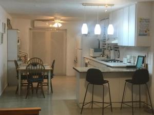 a kitchen with a table and chairs and a dining room at Luquillo Beach Vacation in Luquillo