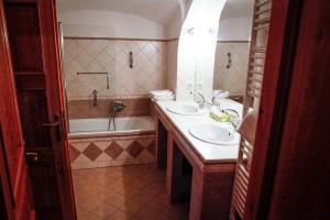 y baño con 2 lavabos y bañera. en Erzsébet Pince, en Tokaj