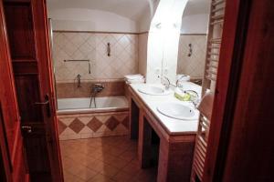 a bathroom with two sinks and a bath tub at Erzsébet Pince in Tokaj +13 photos