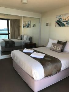 a hotel room with two beds and a balcony at Gemini Resort in Caloundra