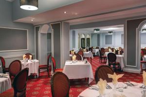 a dining room with white tables and chairs at Belvilla Crewe Arms Hotel in Crewe