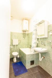 a bathroom with a sink and a toilet at Apartments Adriatic in Sveti Stefan