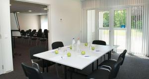 a meeting room with a white table and chairs at Best Western Hotel Wavre in Wavre
