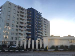 a large apartment building in front of a building at Departamento Edificio Playa Blanca in La Serena