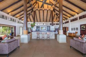 a large living room with couches and a bar at Eratap Beach Resort in Port Vila