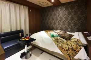 a bedroom with a bed and a table with a tray of fruit on it at HOTEL le bordeaux -ル ボルドー- in Kurume