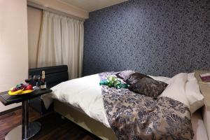 a bedroom with a bed and a table with wine glasses at HOTEL le bordeaux -ル ボルドー- in Kurume +6 photos