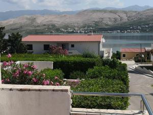 a house with a view of the water and mountains at Apartments Anastazija in Pag