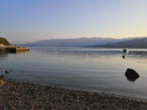 a lake with a group of people in the water at Apartments Anastazija in Pag