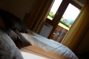 a bedroom with a bed and a large window at Chalet Rasteck in Campo Tures