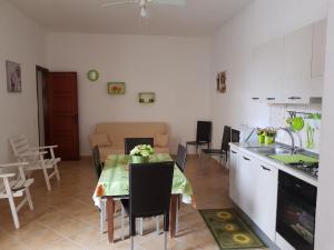 a kitchen and living room with a table and chairs at Casa Gavi in Tre Fontane +4 photos