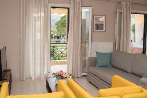 a living room with a couch and a balcony at Mary's House in Lefkada Town