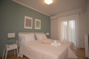 a bedroom with a large white bed with white pillows at Mary's House in Lefkada Town