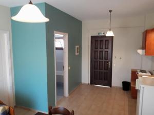 a living room with blue and green walls at Sirios in Finikounta