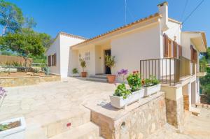 a villa with a patio and a house at Cala Figuera in Cala Figuera