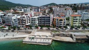 an aerial view of a city with buildings and the water at Apartments Palma in Dobra Voda