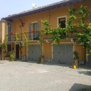 a building with four garage doors and a balcony at Corte Delle Rose in Voghera