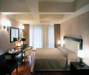 Postel nebo postele na pokoji v ubytování Hotel La Fenice