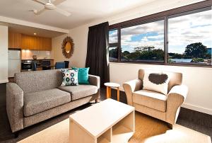 a living room with a couch and two chairs at St Catherine's on Park in Perth