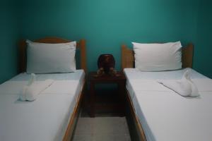 Postel nebo postele na pokoji v ubytování Lylie Hotel