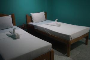 Postel nebo postele na pokoji v ubytování Lylie Hotel